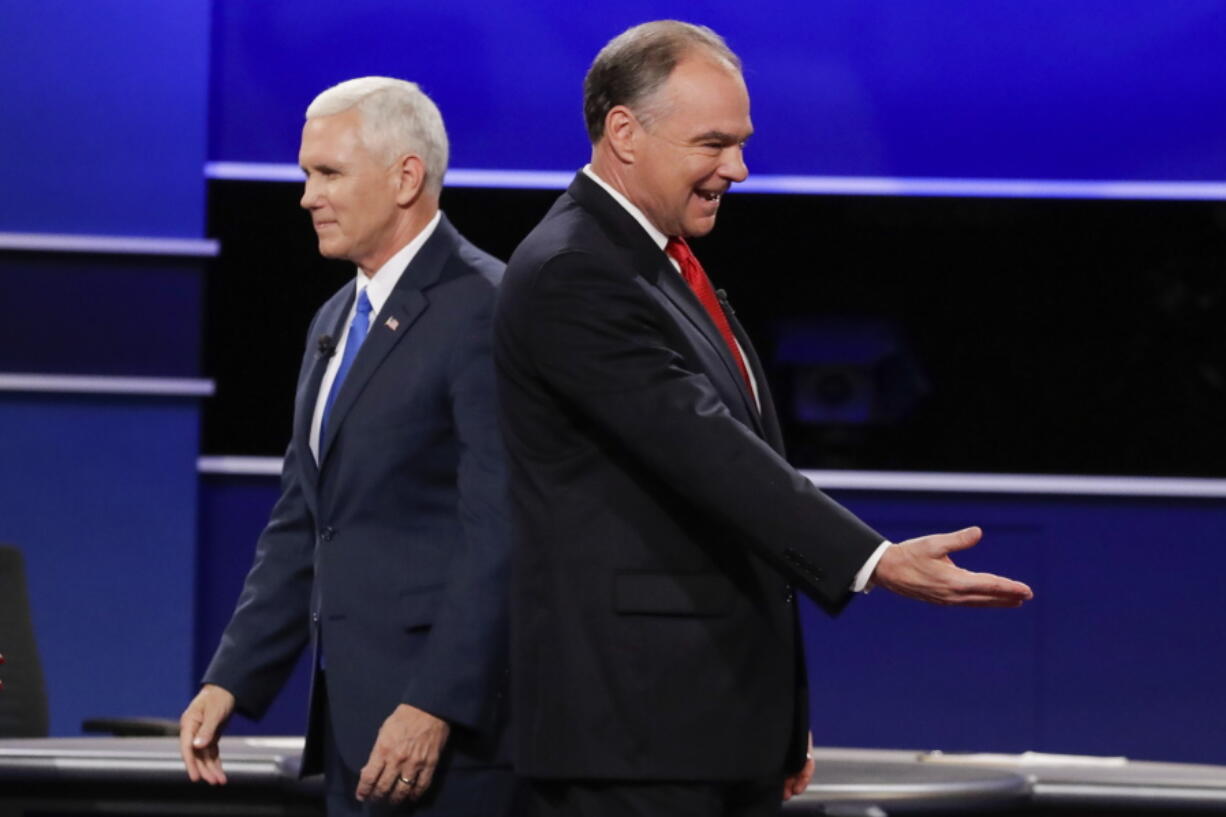 Republican vice-presidential nominee Gov. Mike Pence and Democratic vice-presidential nominee Sen. Tim Kaine, right, walk past each other after the vice-presidential debate at Longwood University in Farmville, Va., Tuesday, Oct. 4, 2016.