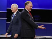 Republican vice-presidential nominee Gov. Mike Pence and Democratic vice-presidential nominee Sen. Tim Kaine, right, walk past each other after the vice-presidential debate at Longwood University in Farmville, Va., Tuesday, Oct. 4, 2016.