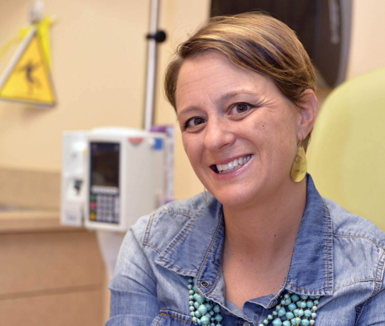 Lara MacGregor, a participant in a new crowdsourcing project for metastatic breast cancer research, poses for a photo as she undergoes treatment at the Norton Cancer Center in Louisville, Ky., on Wednesday. (AP Photo/Timothy D.