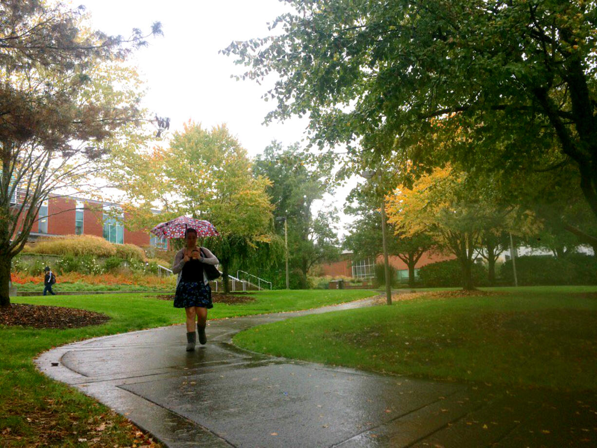 Students at Clark College try to stay dry between classes on Thursday.