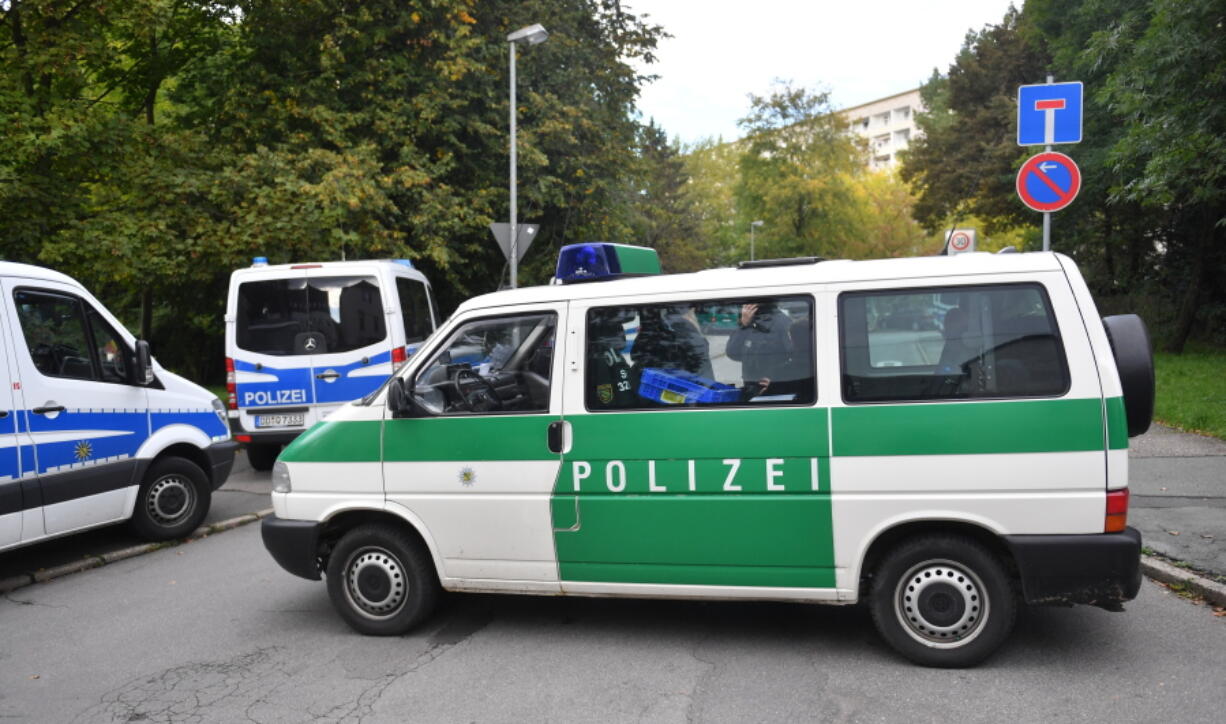 Police block a street in the Yorck area of Chemnitz, eastern Germany, Sunday. German police searched nationwide for a 22-year-old Syrian man believed to have been preparing a bombing attack, who slipped through their fingers as they were closing in on him, and were questioning a second Syrian man on suspicion he was involved in the plot.