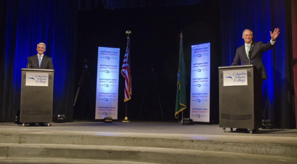 Republican candidate Bill Bryant, left, and Democratic Gov. Jay Inslee take the stage at Columbia Basin College in Pasco for their gubernatorial debate Wednesday night.