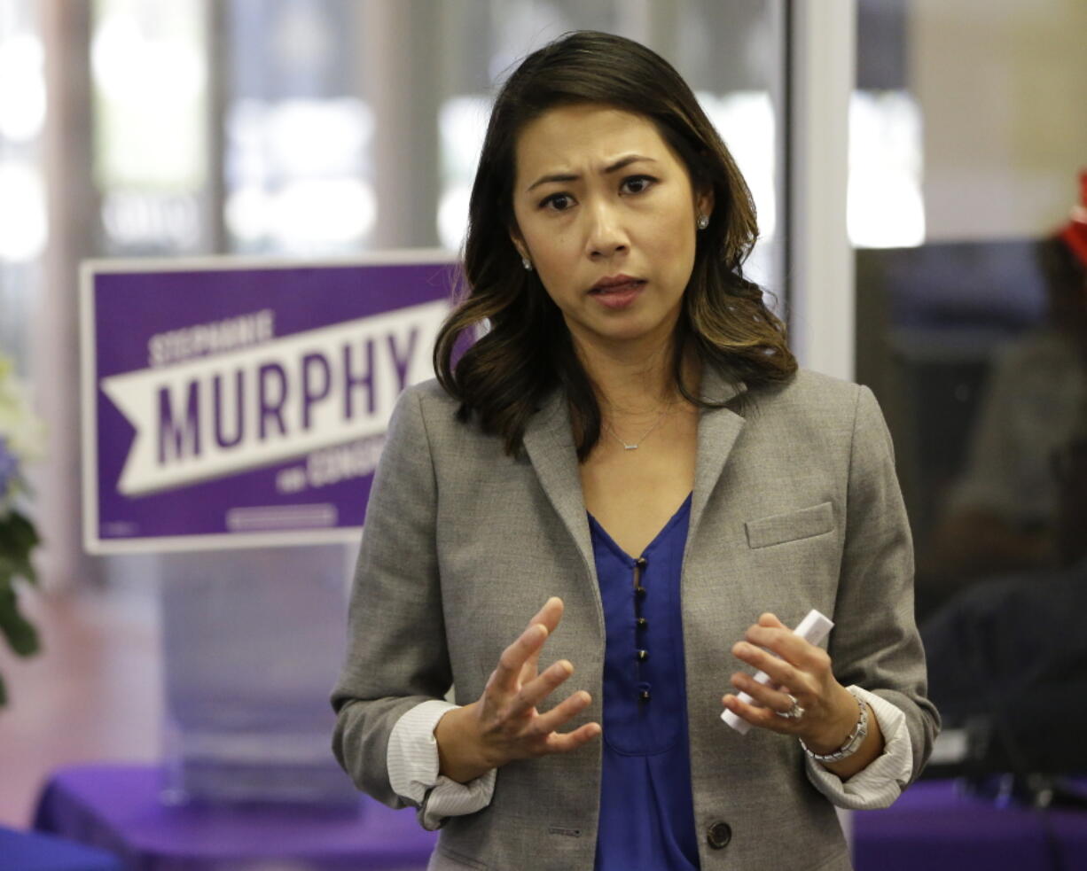 In this photo taken Oct. 18, 2016, Florida Democratic Congressional candidate Stephanie Murphy meets with voters at a senior center in Altamonte Springs, Fla. Rep. John Mica, R-Fla., is seeking a 13th term in Congress from central Florida, but itC?Us not an easy path. The veteran Republican tells supporters turnout is critical. And heC?Us offers them this advice about his re-election contest: ``DonC?Ut let it get caught up in any of the other races or issues.C?u That seems code for Donald Trump, whose presidential run carries mixed blessings in a tight district. More than Trump is threatening MicaC?Us career. In a battle of old school versus new, Mica faces Murphy, a 38-year-old political neophyte.