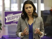 In this photo taken Oct. 18, 2016, Florida Democratic Congressional candidate Stephanie Murphy meets with voters at a senior center in Altamonte Springs, Fla. Rep. John Mica, R-Fla., is seeking a 13th term in Congress from central Florida, but itC?Us not an easy path. The veteran Republican tells supporters turnout is critical. And heC?Us offers them this advice about his re-election contest: ``DonC?Ut let it get caught up in any of the other races or issues.C?u That seems code for Donald Trump, whose presidential run carries mixed blessings in a tight district. More than Trump is threatening MicaC?Us career. In a battle of old school versus new, Mica faces Murphy, a 38-year-old political neophyte.