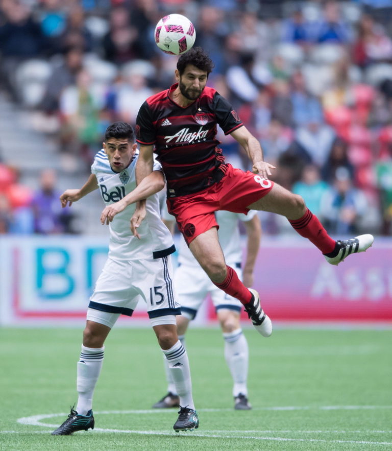 Vancouver Whitecaps&#039; Matias Laba, left, and Portland Timbers&#039; Diego Valeri vie for the ball during the first half of an MLS soccer game in Vancouver, British Columbia, on Sunday Oct. 23, 2016.