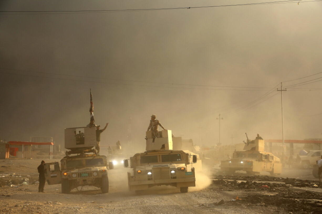 An Iraqi military convoy advances Wednesday toward the city of Mosul.