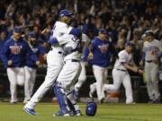 Chicago Cubs catcher Willson Contreras and relief pitcher Aroldis Chapman (54) celebrate after Game 6 of the National League baseball championship series against the Los Angeles Dodgers Saturday, Oct. 22, 2016, in Chicago. The Cubs won 5-0 to win the series and advance to the World Series against the Cleveland Indians. (AP Photo/David J.