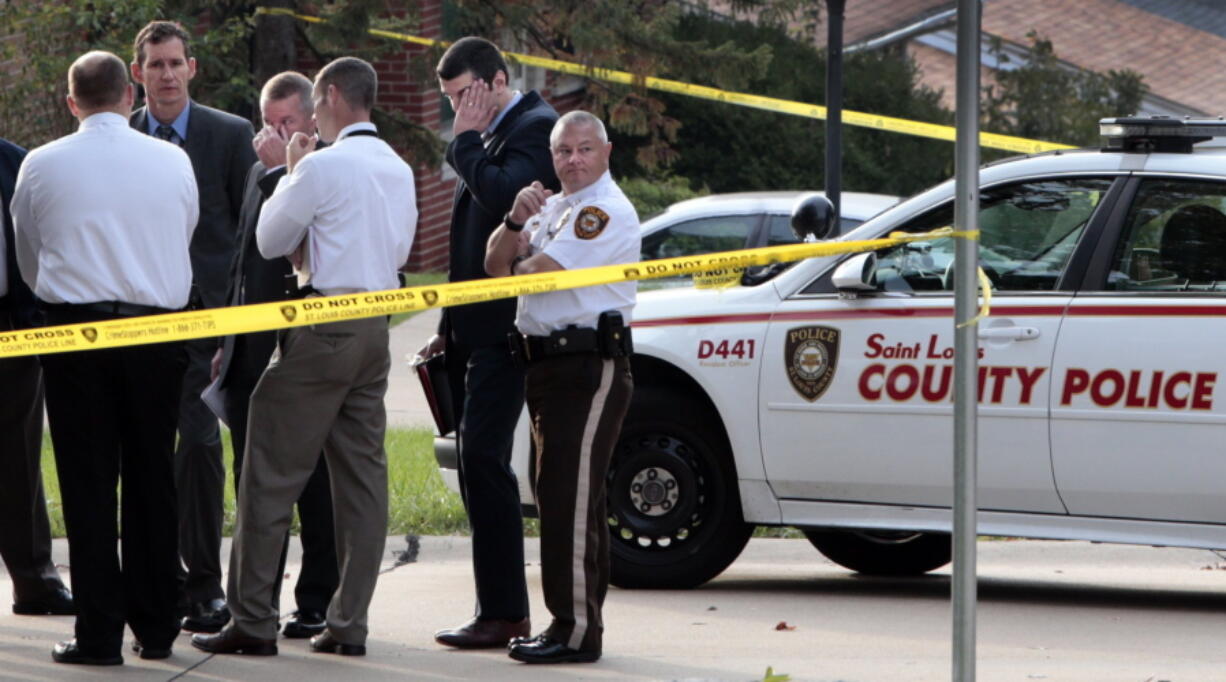 St. Louis County officers investigate the scene where a fellow county officer and a suspect were shot early on Thursday on Arno Drive in Green Park Mo. Police spokesman Benjamin Granda says the officer and suspect are undergoing &quot;life-saving treatment&quot; following the pre-dawn shooting Thursday at a home in Green Park, a small middle class community in south St. Louis County. (Robert Cohen/St.