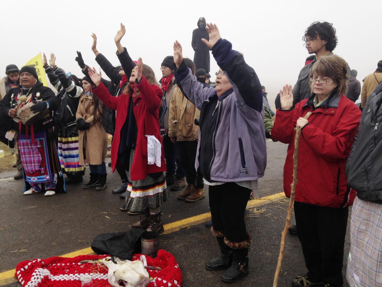 Protesters against the construction of the Dakota Access oil pipeline block a highway in near Cannon Ball, N.D., on Wednesday, Oct. 26, 2016. Law enforcement officials have asked people protesting the Dakota Access oil pipeline to vacate an encampment on private land, and the protesters said no. Protesters are trying to halt construction of the pipeline they fear will harm cultural sites and drinking water for the Standing Rock Sioux.