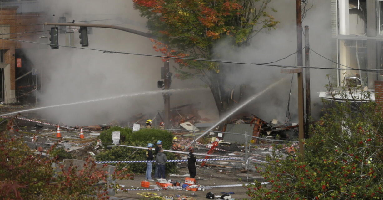 Firefighters battle a blaze after a gas explosion in Portland on Wednesday. A powerful natural gas explosion that neighbors said felt like an earthquake rocked the busy a busy Portland, Oregon, shopping district and started a fire that sent a huge plume of smoke over the heart of the city.