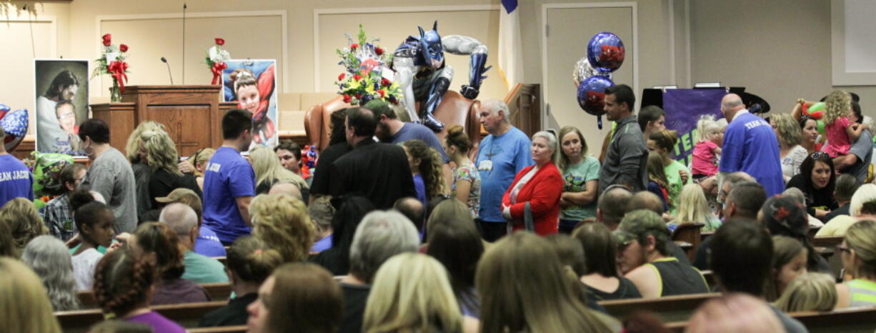 Friends and family, some in blue &quot;Team Jacob&quot; t-shirts, line up Tuesday at a wake for Jacob Hall, 6, at Oakdale Baptist Church in Townville, S.C. Jacob, a classmate and a teacher were shot last Wednesday as they left for recess; a third child was also injured.