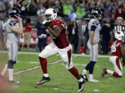 Arizona Cardinals linebacker Kareem Martin, center, reacts to Seattle Seahawks kicker Stephen Hauschka's, left, missed game-winning field goal attempt during overtime an NFL football game against the Arizona Cardinals, Sunday, Oct. 23, 2016, in Glendale, Ariz. The game ended in overtime in a 6-6 tie.