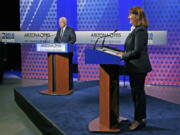 Arizona Democratic Rep. Ann Kirkpatrick, right, and incumbent Republican Sen. John McCain, left, listen to the debate moderators for the debate rules prior to their only scheduled debate before next month&#039;s general election Monday in Phoenix. (AP Photo/Ross D.