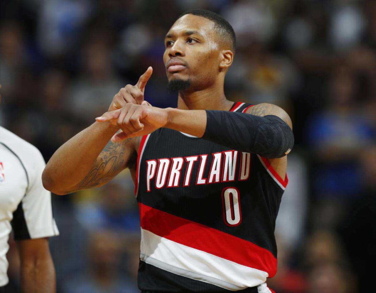 Portland Trail Blazers guard Damian Lillard gestures after hitting the winning basket with .3 seconds remaining in overtime of an NBA basketball game against the Denver Nuggets on Saturday, Oct. 29, 2016 in Denver. Portland won 115-113.