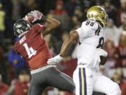 Washington State safety Charleston White (4) intercepts a pass intended for UCLA tight end Austin Roberts (88) near the end of an NCAA college football game in Pullman, Wash., Saturday, Oct. 15, 2016. Washington State won 27-21.