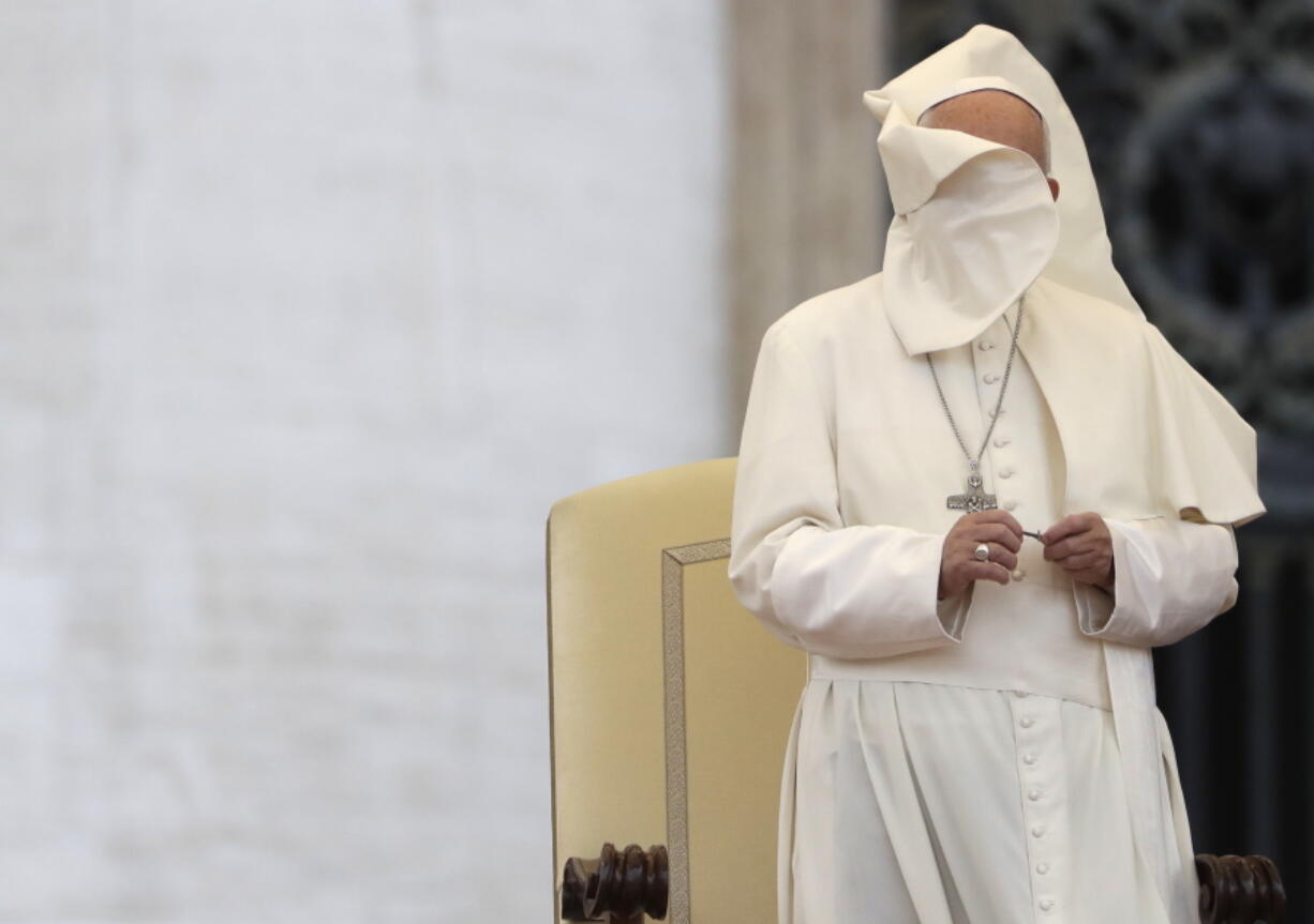 A gust of wind blows the mantle of Pope Francis as he leads a Marian vigil prayer in St. Peter&#039;s square at the Vatican on Saturday.