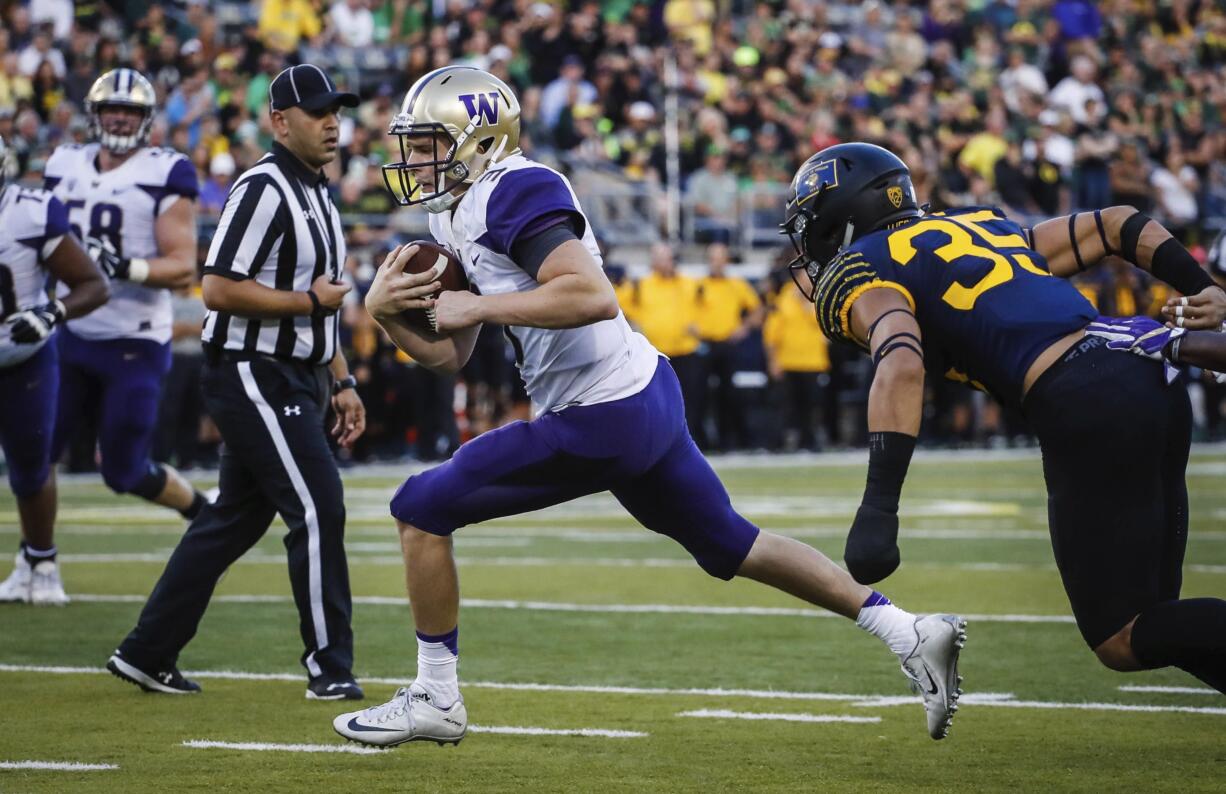 Washington quarterback Jake Browning (3) scores on the last drive of the first half against Oregon an NCAA college football game Saturday, Oct. 8, 2016, in Eugene, Ore.