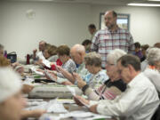 Republican observer David Arnett, standing, keeps an eye on the process at the Clark County Department of Elections on Wednesday afternoon.