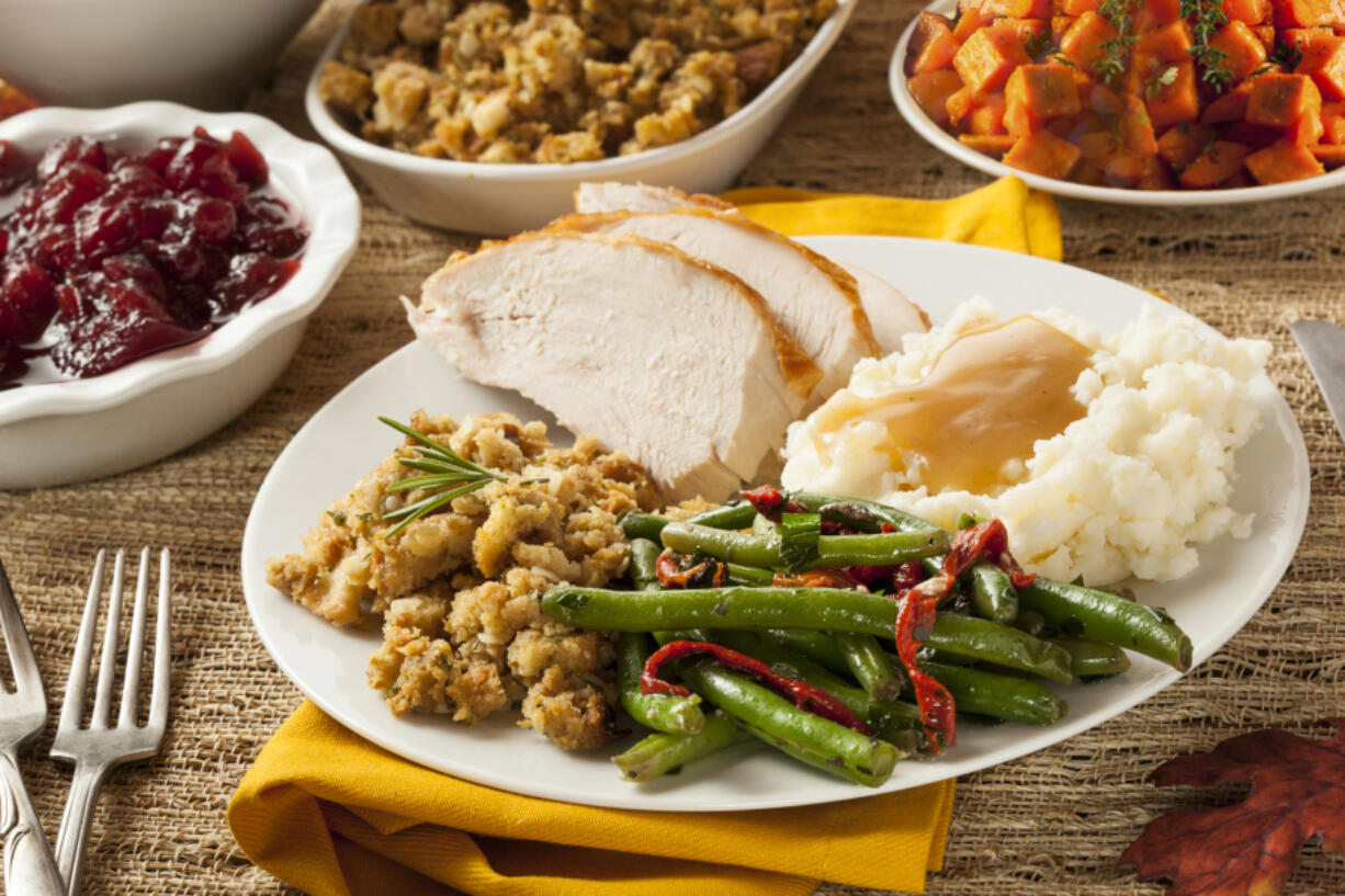 Homemade turkey Thanksgiving dinner with mashed potatoes, stuffing, and green beans.