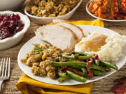 Homemade turkey Thanksgiving dinner with mashed potatoes, stuffing, and green beans.