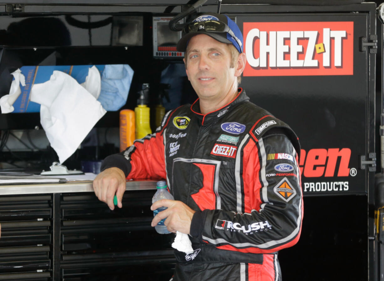 Greg Biffle takes a break in his garage during NASCAR Sprint Cup auto racing practice at Daytona International Speedway, Friday, July 1, 2016, in Daytona Beach, Fla.