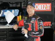 Greg Biffle takes a break in his garage during NASCAR Sprint Cup auto racing practice at Daytona International Speedway, Friday, July 1, 2016, in Daytona Beach, Fla.