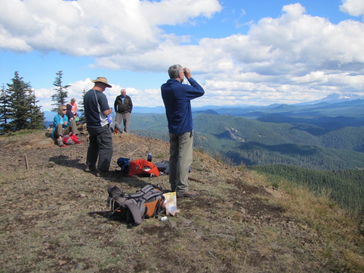 A group of hikers in September take a break atop Observation Peak in the Trapper Creek Wilderness of the Gifford Pinchot National Forest.