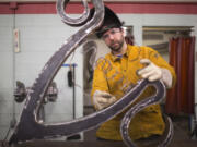 Scott Patzer works on a metal lamp at Clark College&#039;s metal sculpting class in Vancouver on Nov. 14. Patzer is an artist pursuing a degree in welding.