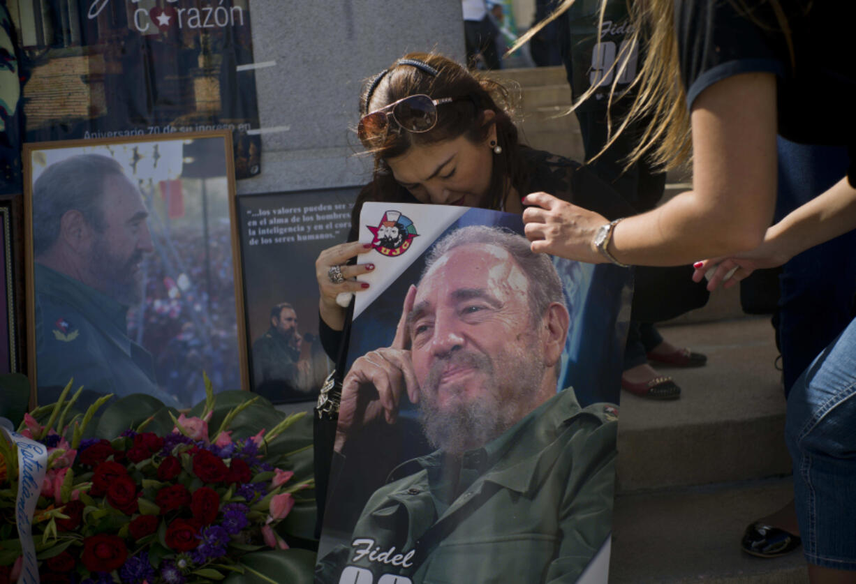 People with images of Fidel Castro gather in Havana, Cuba, on Saturday, the day after his death. Cuba will observe nine days of mourning for the former president who ruled for half a century.