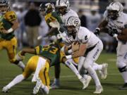 Skyview High School's Brody Barnum (2) is tackled by Richland High School's Josh Mendoza (23) Saturday during the 4A semifinal football game at Neil F.