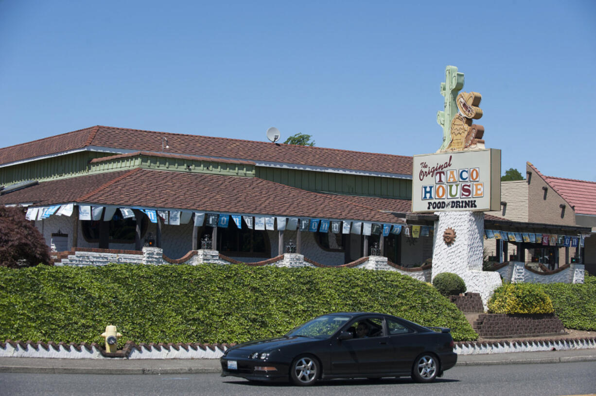 A motorist drives past The Original Taco House on Northeast Coxley Drive in June. Owners of the restaurant closed their Vancouver location for good on Sunday.