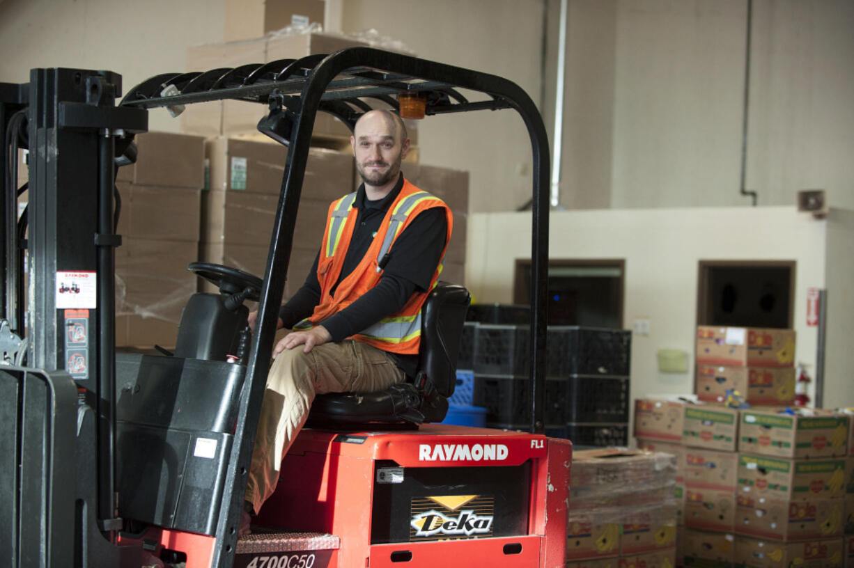 Hundreds of volunteers help Tim Hensley accomplish his job packing, storing and distributing food at the Clark County Food Bank -- more than 50 tons of food a day.