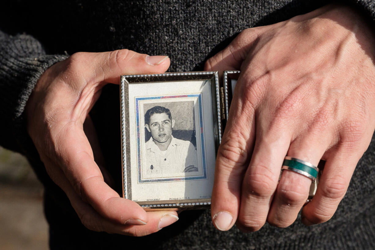 Vancouver resident Jeremiah Thompson holds a photo of his grandfather Dewey E. Clark when he was 22 years old. Thompson is running his first marathon, the Athens Marathon, today in honor of his grandfather, who ran 12 marathons before his death last year.