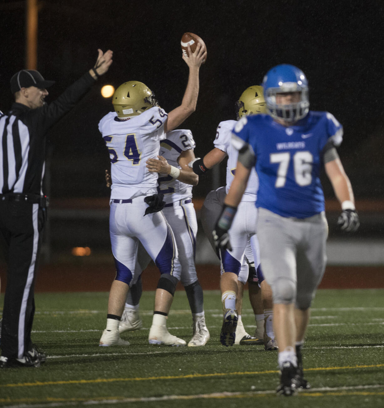 LEADOPTION Connell players celebrate after recovering a La Center fumble as Caiden Krout (76) walks past in the third quarter at McKenzie Stadium on Saturday night, Nov. 26, 2016.