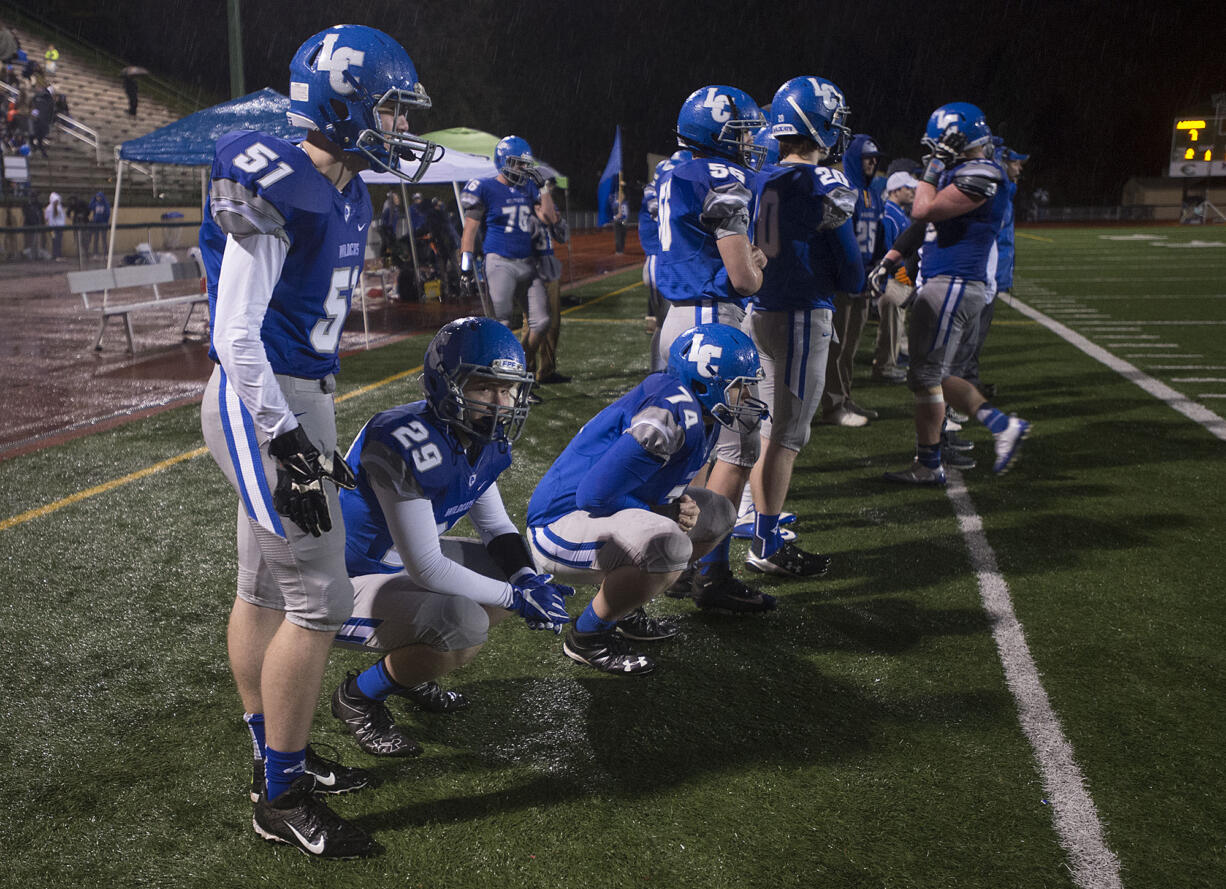 LEADOPTION La Center players watch the final minutes of the game from the sidelines at McKenzie Stadium on Saturday night, Nov. 26, 2016.