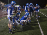 LEADOPTION La Center players watch the final minutes of the game from the sidelines at McKenzie Stadium on Saturday night, Nov. 26, 2016.