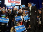 Gov. Jay Inslee waves to supporters as he heads on stage with his wife, Trudi Inslee, at an election night party for Democrats on Tuesday in Seattle.