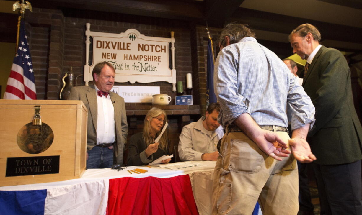 Voters in Dixville Notch, N.H., get their ballots Tuesday, Nov. 8, 2016, in Dixville Notch, N.H. The residents in town voted just after midnight.