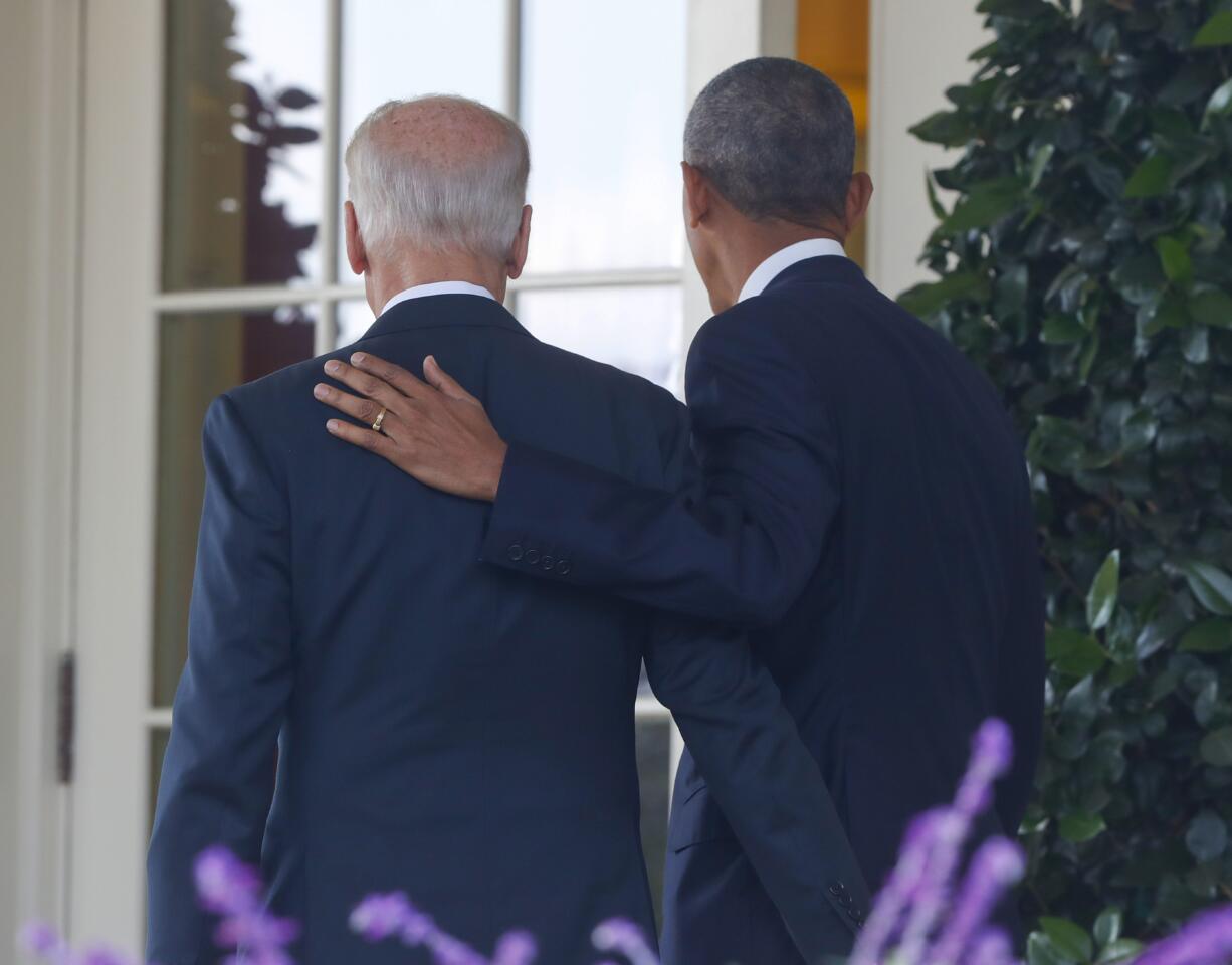 President Barack Obama, accompanied by Vice President Joe Biden, walks back into the Oval Office of the White House in Washington, Wednesday, Nov. 9, 2016, after speaking about the election in the Rose Garden.