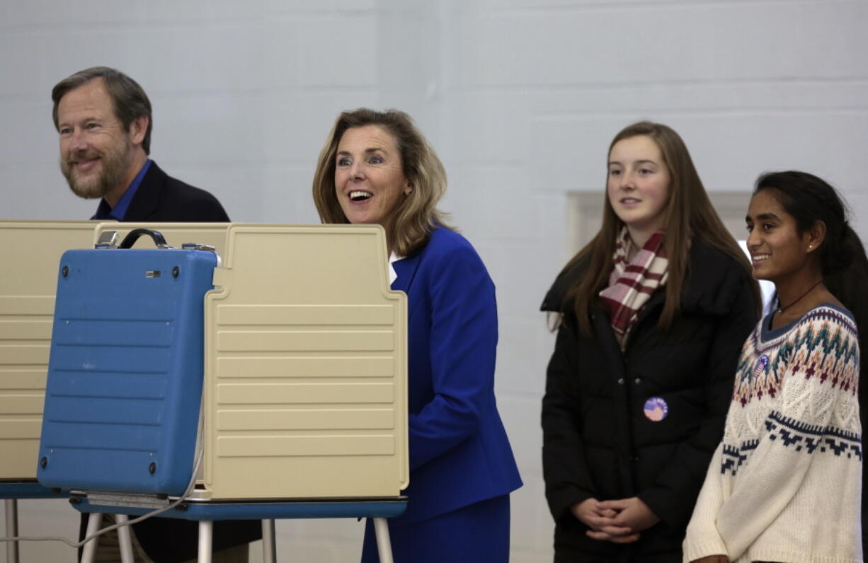 Pennsylvania Democratic Senate candidate Katie McGinty, center, casts her ballot alongside her husband Karl Hausker, and two of their three daughters Tuesday  in Wayne, Pa. McGinty is running against Sen. Pat Toomey, R-Pa.