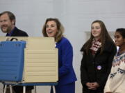 Pennsylvania Democratic Senate candidate Katie McGinty, center, casts her ballot alongside her husband Karl Hausker, and two of their three daughters Tuesday  in Wayne, Pa. McGinty is running against Sen. Pat Toomey, R-Pa.