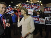 Sen. Lisa Murkowski, R-Alaska, center, reacts to news of her re-election in Anchorage Alaska on Tuesday.