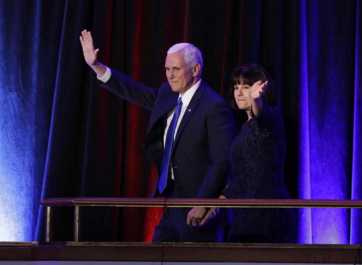 Vice-President-elect Mike Pence and his wife Karen Pence waves as they arrive during his election night rally, Wednesday in New York.