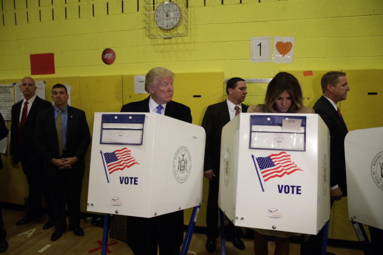 Republican presidential candidate Donald Trump looks at his wife, Melania, as they cast their votes at PS-59, Tuesday in New York.