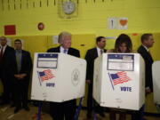 Republican presidential candidate Donald Trump looks at his wife, Melania, as they cast their votes at PS-59, Tuesday in New York.