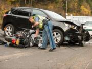 A state trooper examined a motorcycle v. SUV crash near Beacon Rock State Park on Thursday afternoon. Both drivers were hospitalized.