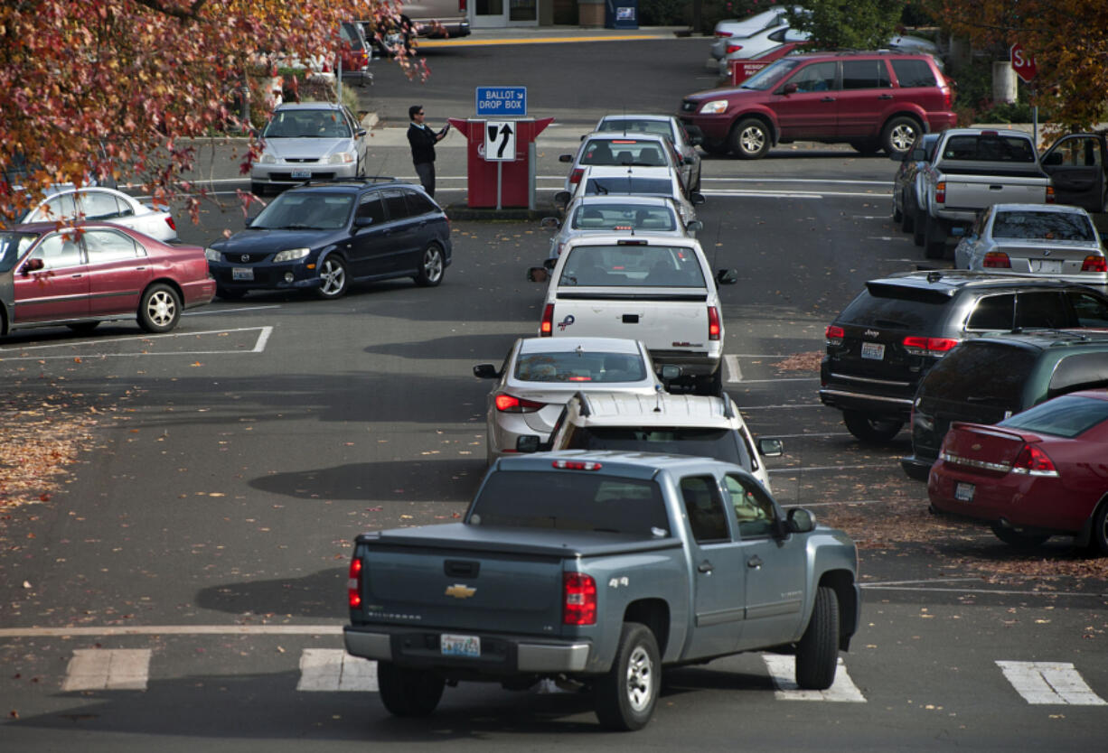 A steady stream of voters drop off their ballots along West 14th Street on Monday afternoon, the day before the election.