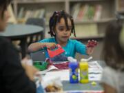 Vancouver toddler Sifun Ababiya, 3, joins the fun at Educational Service District 112’s 1-2-3 Grow and Learn group at Walnut Grove Elementary School on Monday afternoon.