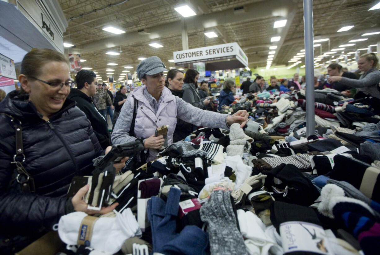 Shannon Lucenti riflers through socks at Fred Meyer in Orchards in Vancouver. The store opened shortly before 5 a.m. with 80 customers in line, store representatives said.