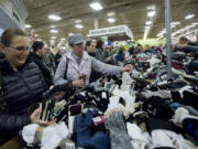 Shannon Lucenti riflers through socks at Fred Meyer in Orchards in Vancouver. The store opened shortly before 5 a.m. with 80 customers in line, store representatives said.